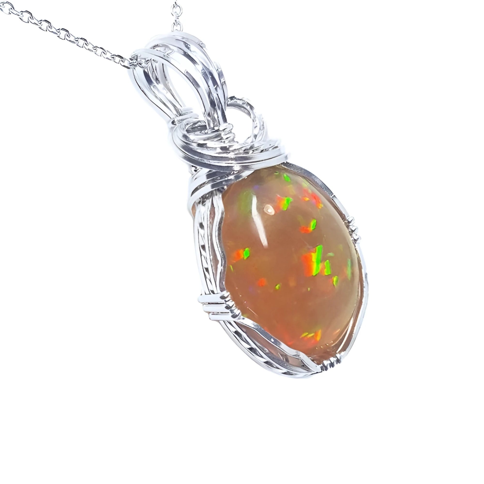 Oval Ethiopian opal pendant with vibrant play of colors and brown pinpoint fire, set in a handcrafted silver wire wrap.