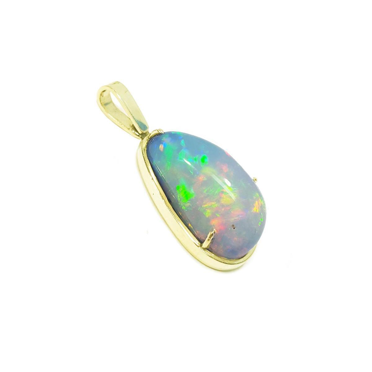 Ethiopian opal pendant with gold setting on a right-side profile white background.