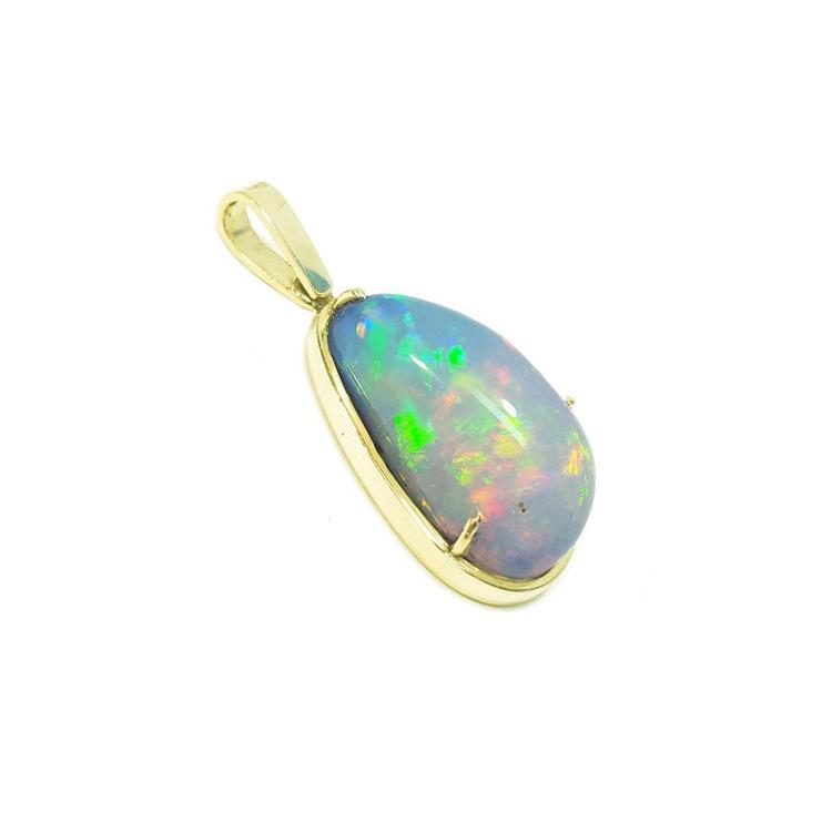 Teardrop Ethiopian opal pendant with vivid rainbow flashes in 14K yellow gold.