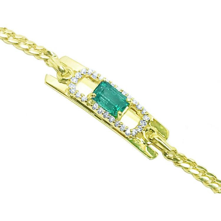 Gold bracelet with a natural emerald and diamonds on a right-side profile view.