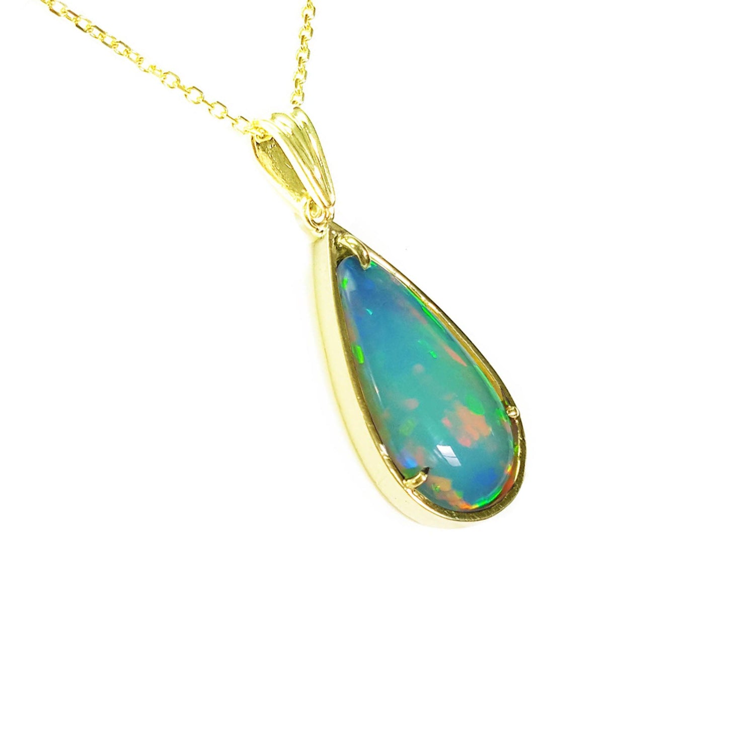 Opal pendant necklace on a gold chain against a white background