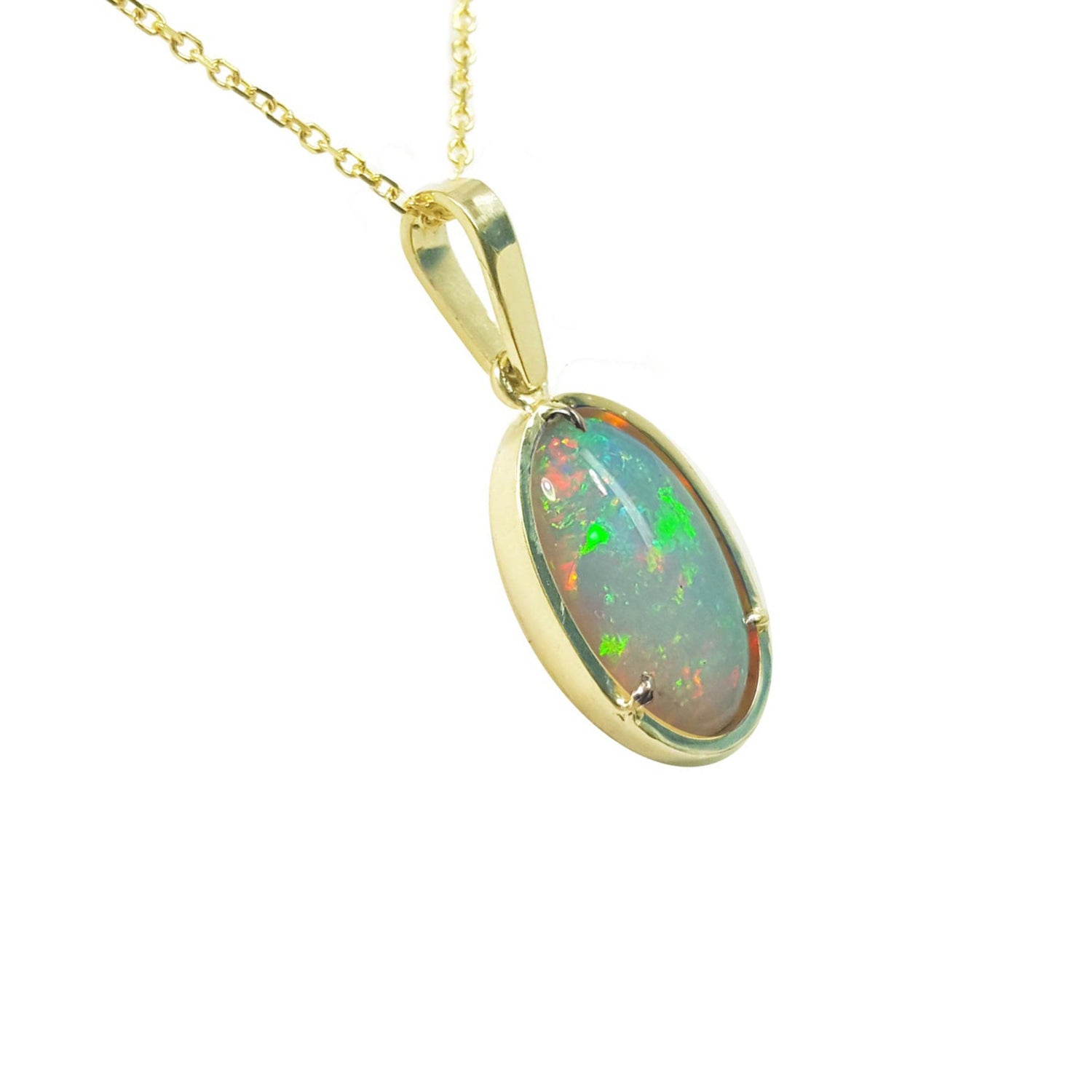 Opal pendant on a gold chain against a white background