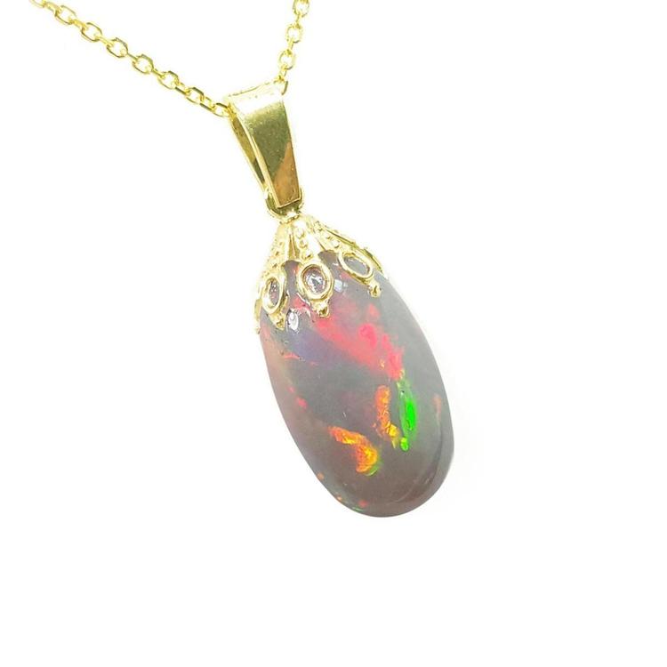 Opal pendant with gold chain on a white background
