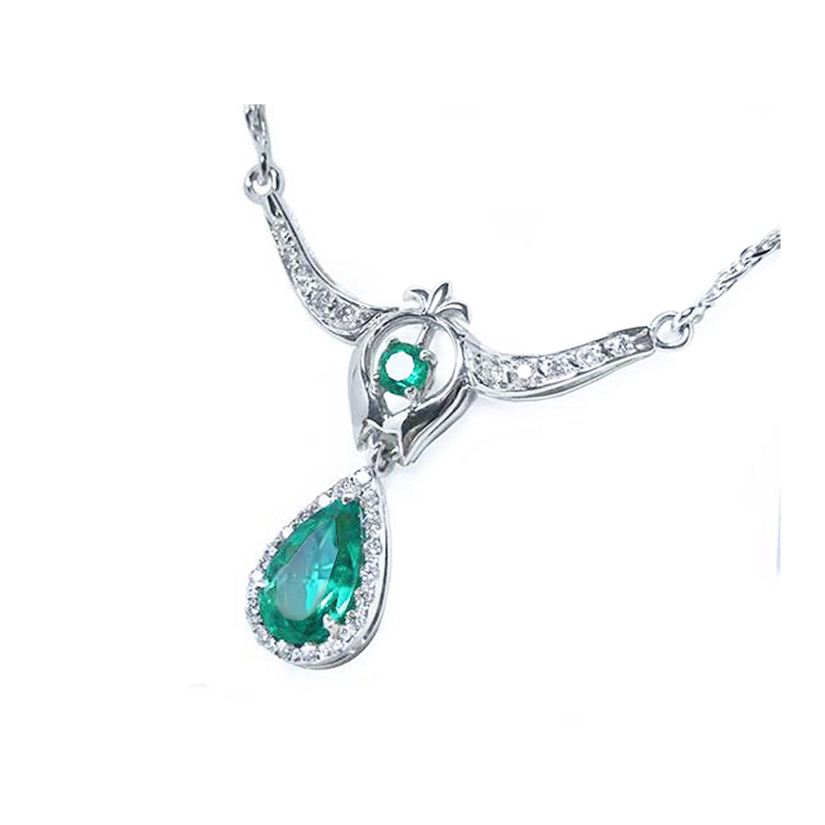 Right side view of a woman&#39;s emerald necklace May birthstone pear-shaped halo diamonds 14k white gold
