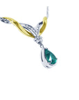 Right side view of a lady's natural teardrop emerald necklace crafted in 14k white and yellow gold 