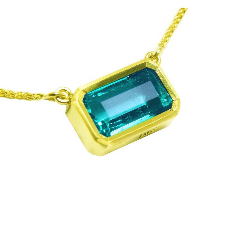 Natural emerald solitaire necklace bezel set east-west orientation handcrafted in 18k yellow gold
