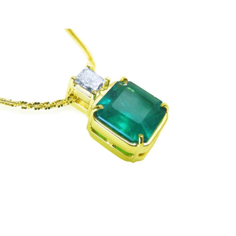 18k gold necklace with an Asscher cut emerald gemstone pendant and princess cut diamond on a white background