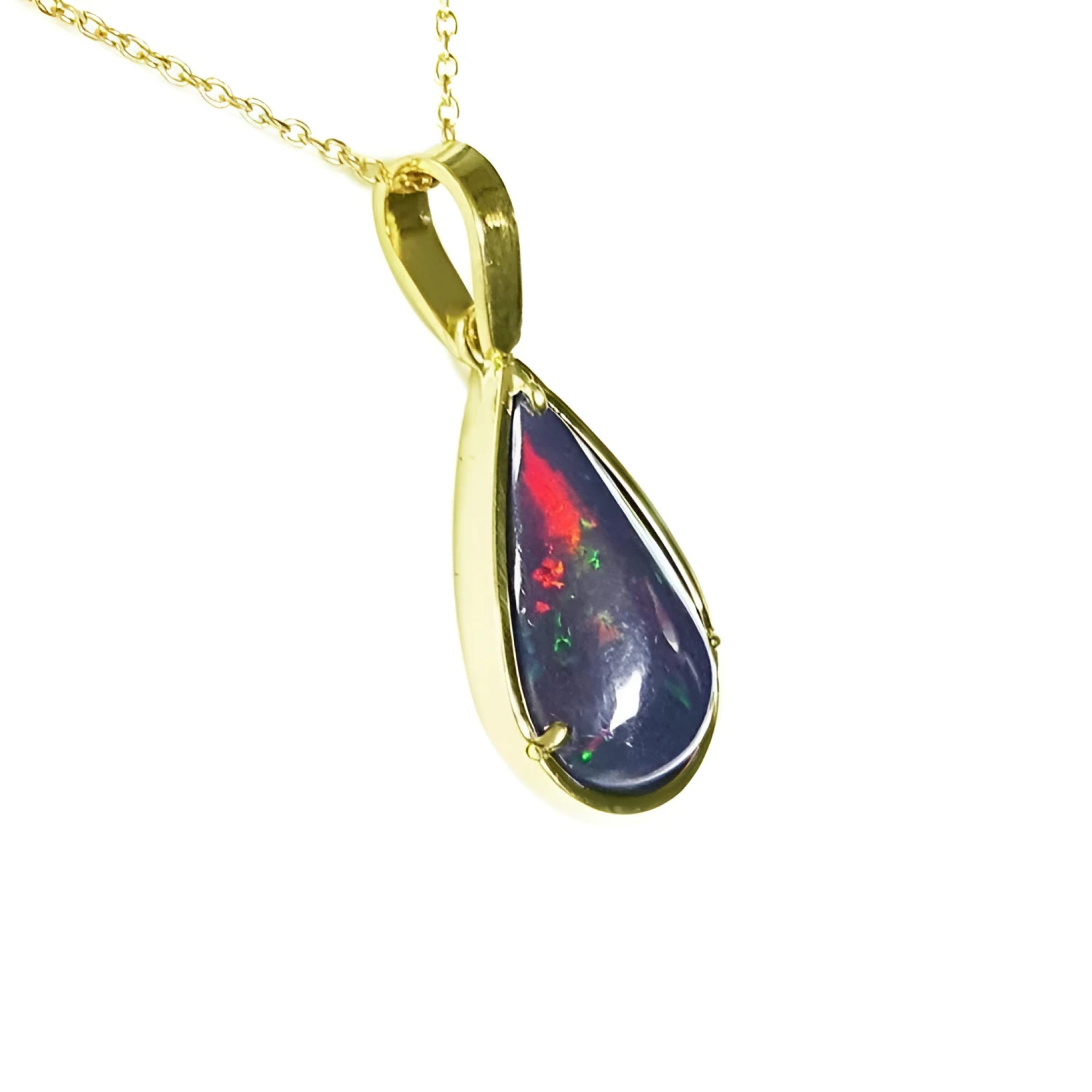 Teardrop Welo black opal pendant with red-orange and blue-green flashes in 14K yellow gold.