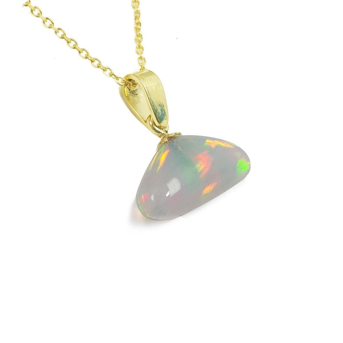 Opal pendant necklace with gold chain on a right-side profile view.