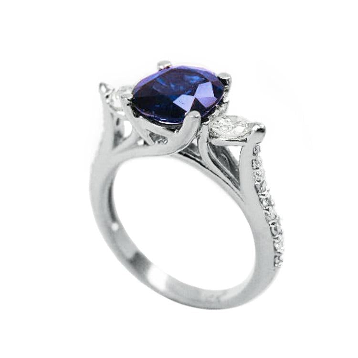 14K white gold ring with a deep blue oval sapphire and accent diamonds.