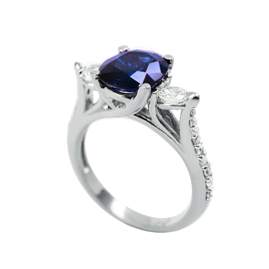14K white gold ring with a deep blue oval sapphire and accent diamonds.
