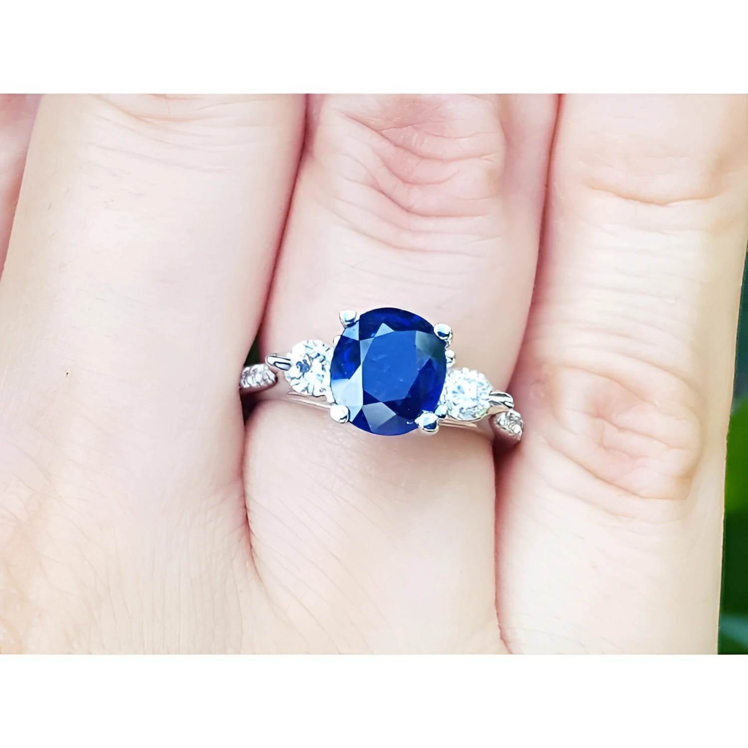 Women's natural blue sapphire ring three stone white gold, accent natural diamonds prong set in a Lucida style.