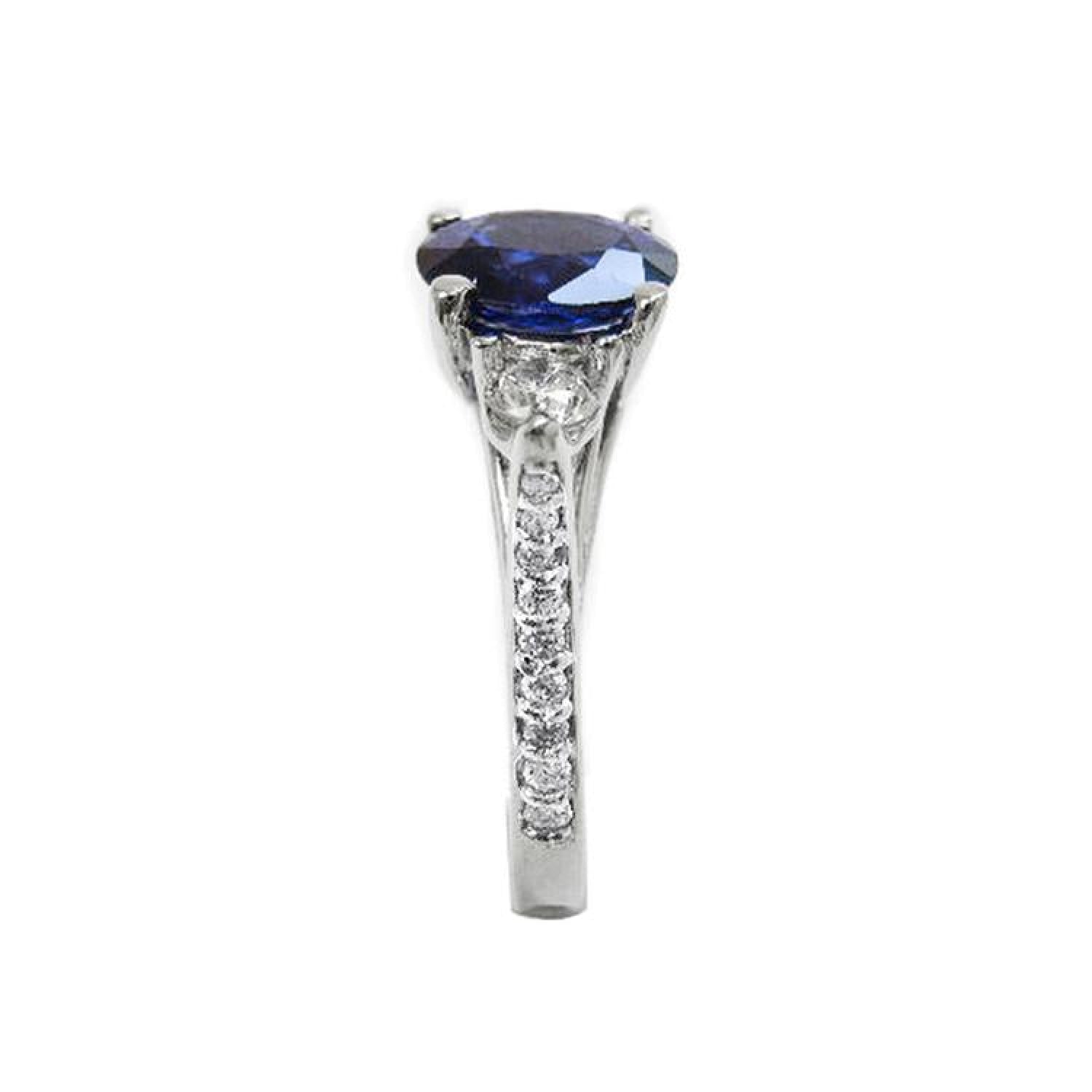 1.84 ct oval blue sapphire ring with side diamonds in 14K white gold.