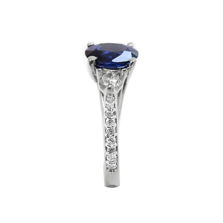 1.84 ct oval blue sapphire ring with side diamonds in 14K white gold.