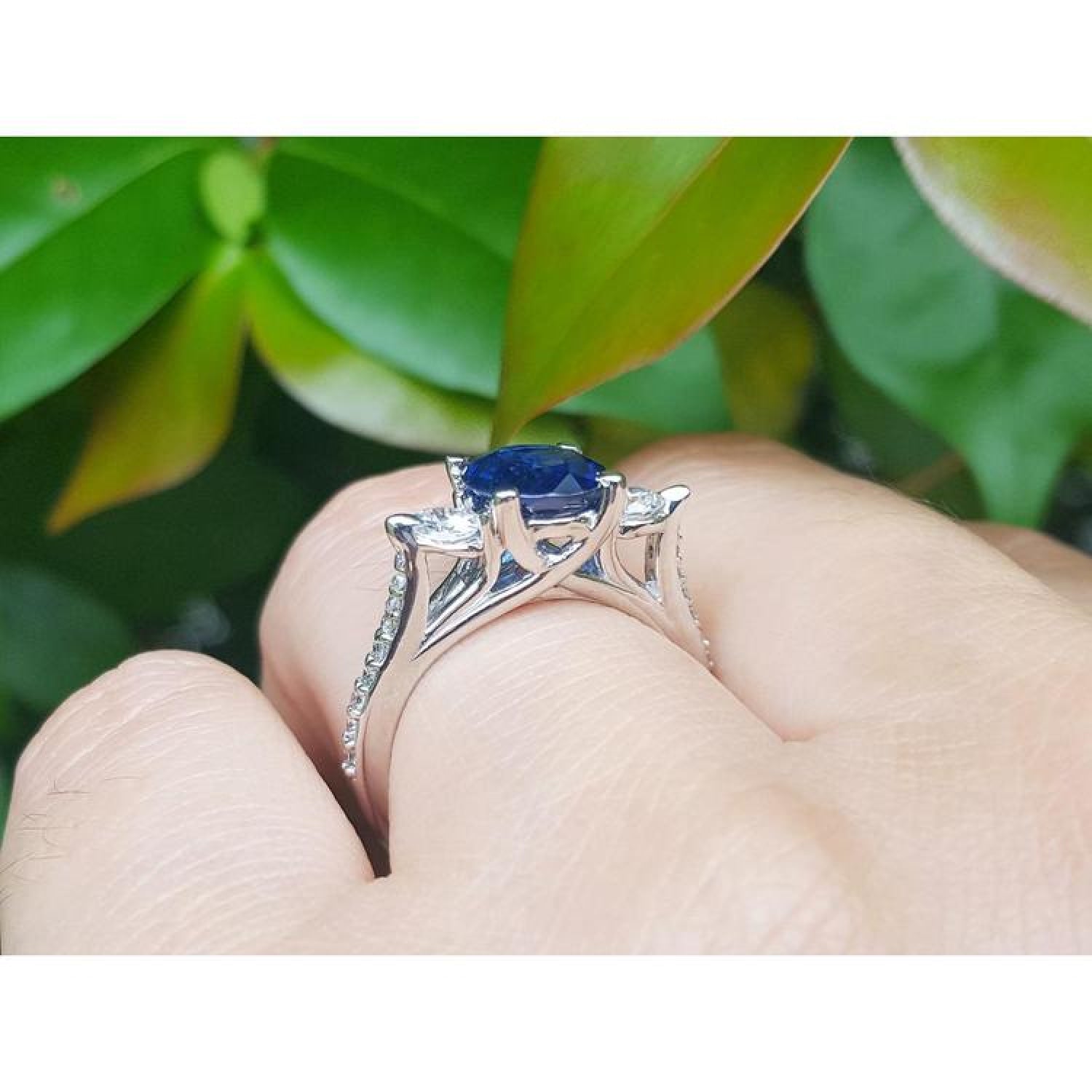 1.84 ct oval blue sapphire ring with side diamonds in 14K white gold.