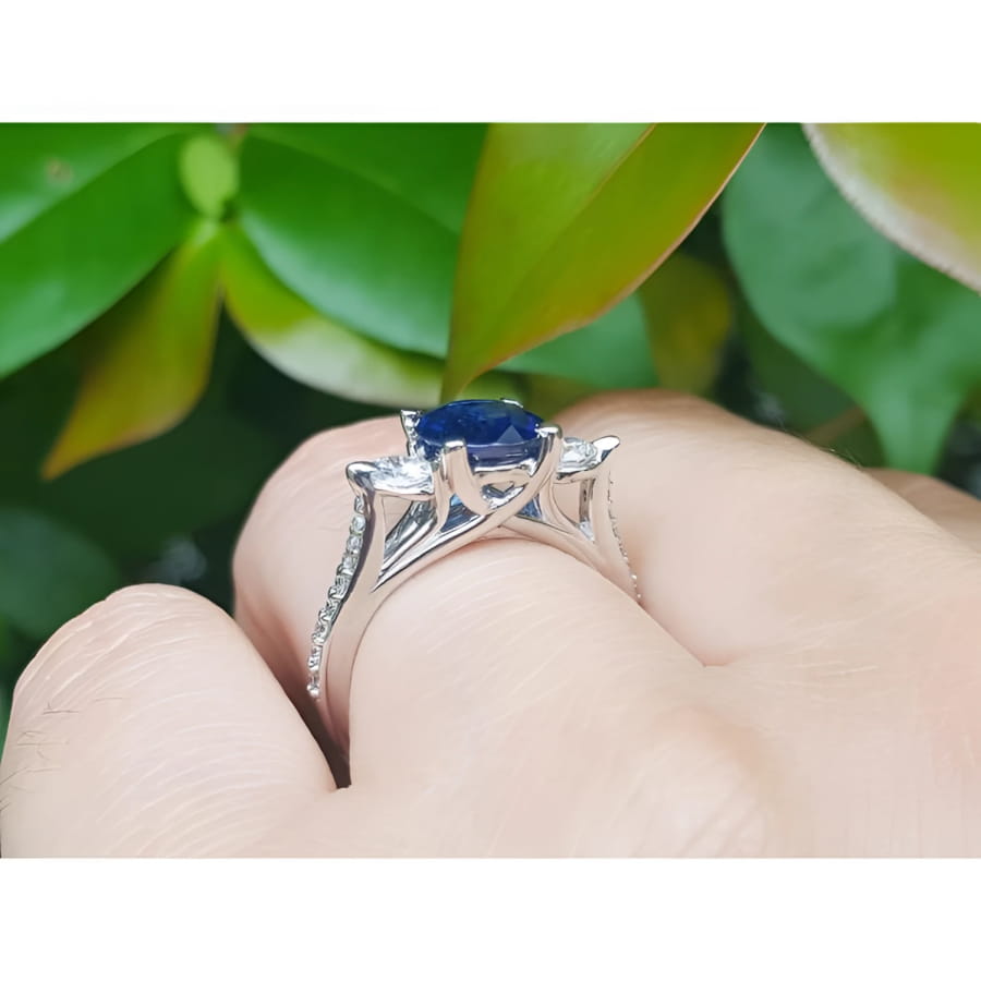 1.84 ct oval blue sapphire ring with side diamonds in 14K white gold.
