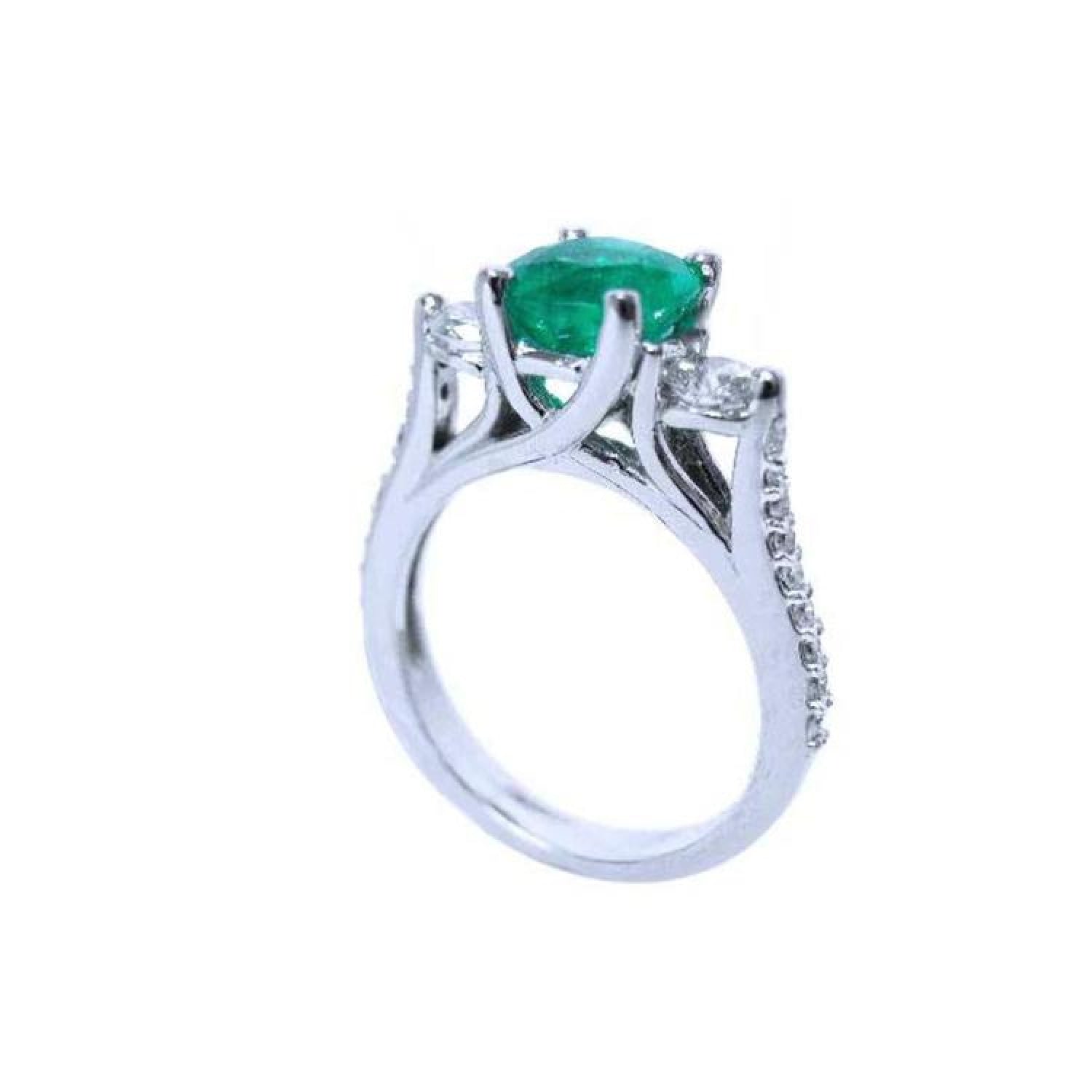 1.38 ct. round emerald three-stone ring with side diamonds in 14K white gold.