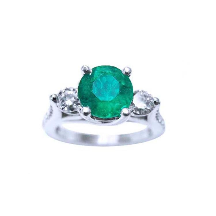 A round cut colombian emerald ring with side natural diamonds in white gold