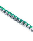 Emerald tennis bracelet round cut Muzo Colombian emeralds 14k white gold sparkling medium deep green color prong set.