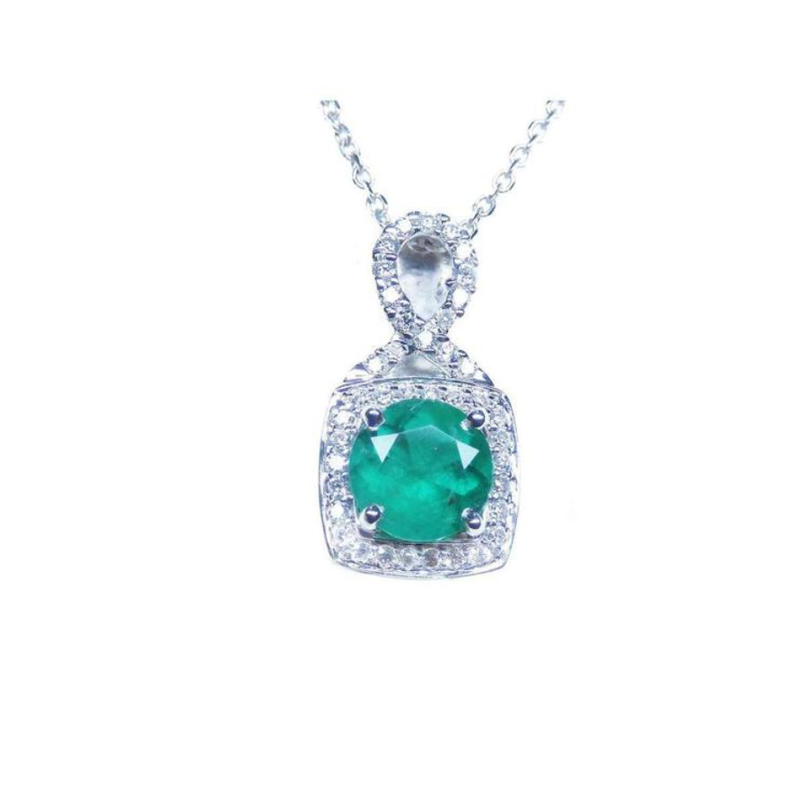 Round deep bluish-green emerald and diamond halo pendant in 18K white gold.
