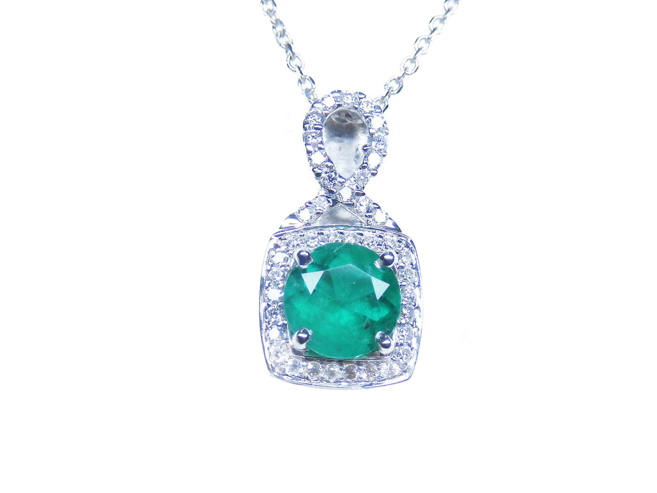Emerald pendant necklace on a front position topside view.