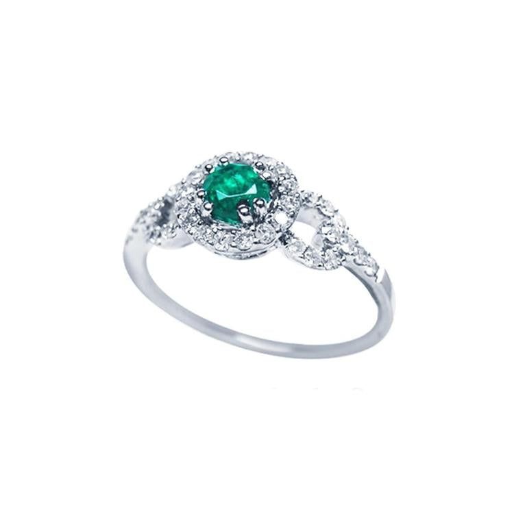 14K white gold ring with a round emerald center stone and diamond halo.