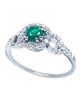 A clear side profile perspective of this natural emerald ring crafted in 14K white gold.