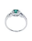 A detailed view of the round cut emerald with a halo diamond ring, highlighting the top, side gallery, and band.