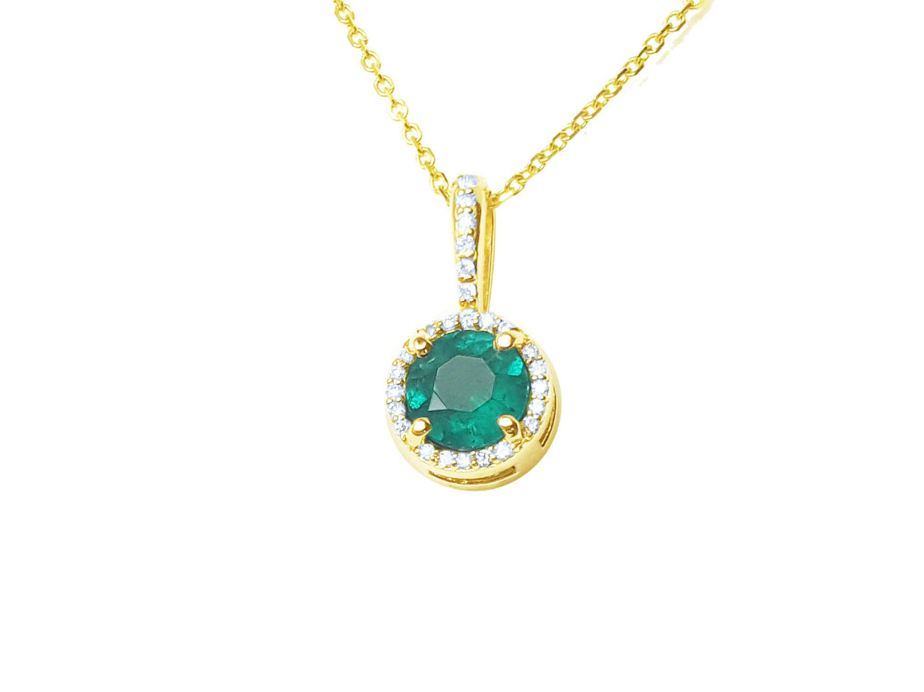 A round cut natural emerald encircled in a halo diamond pendant in yellow gold.