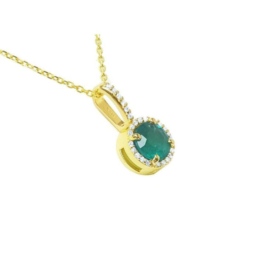 A 14k yellow gold round cut emerald pendant necklace surrounded by a halo of natural diamonds.