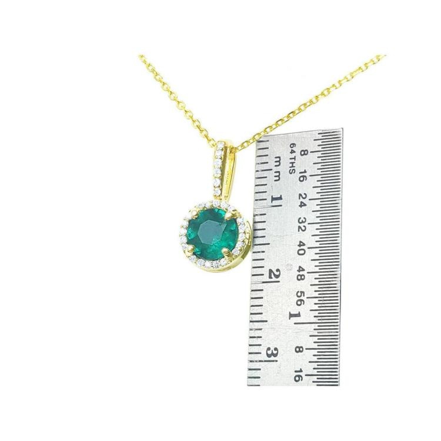 0.88 ct. round Colombian emerald pendant with halo diamonds on a 14K gold chain, next to a ruler.