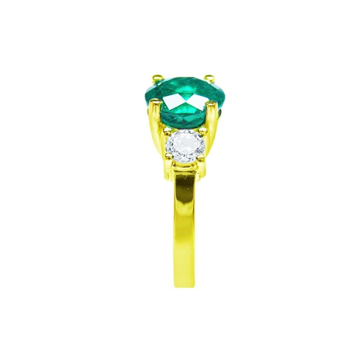 This round cut natural emerald ring with side diamonds made in 18k yellow gold is displaying its top and side profile.