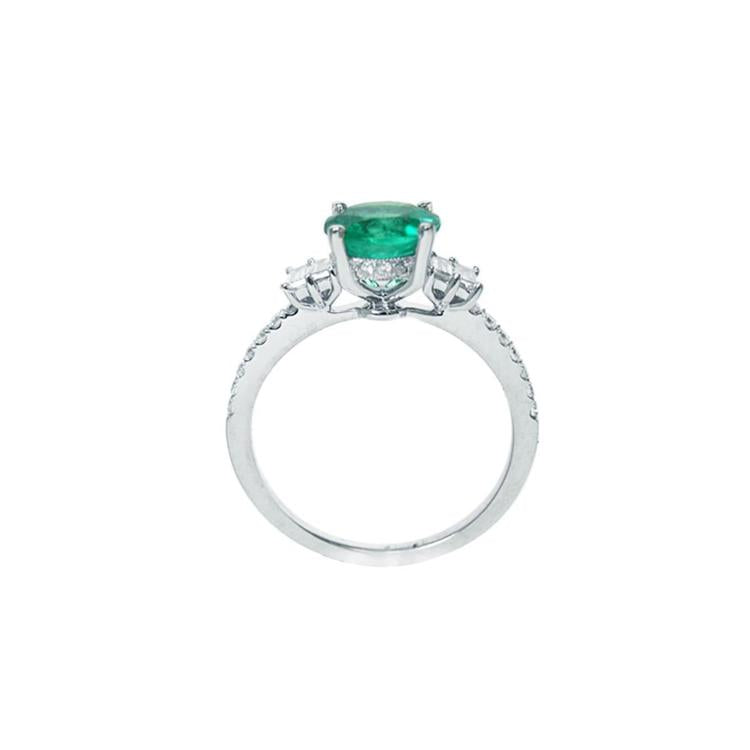 1.10 ct. round Colombian emerald ring with baguette side diamonds in 14K white gold.