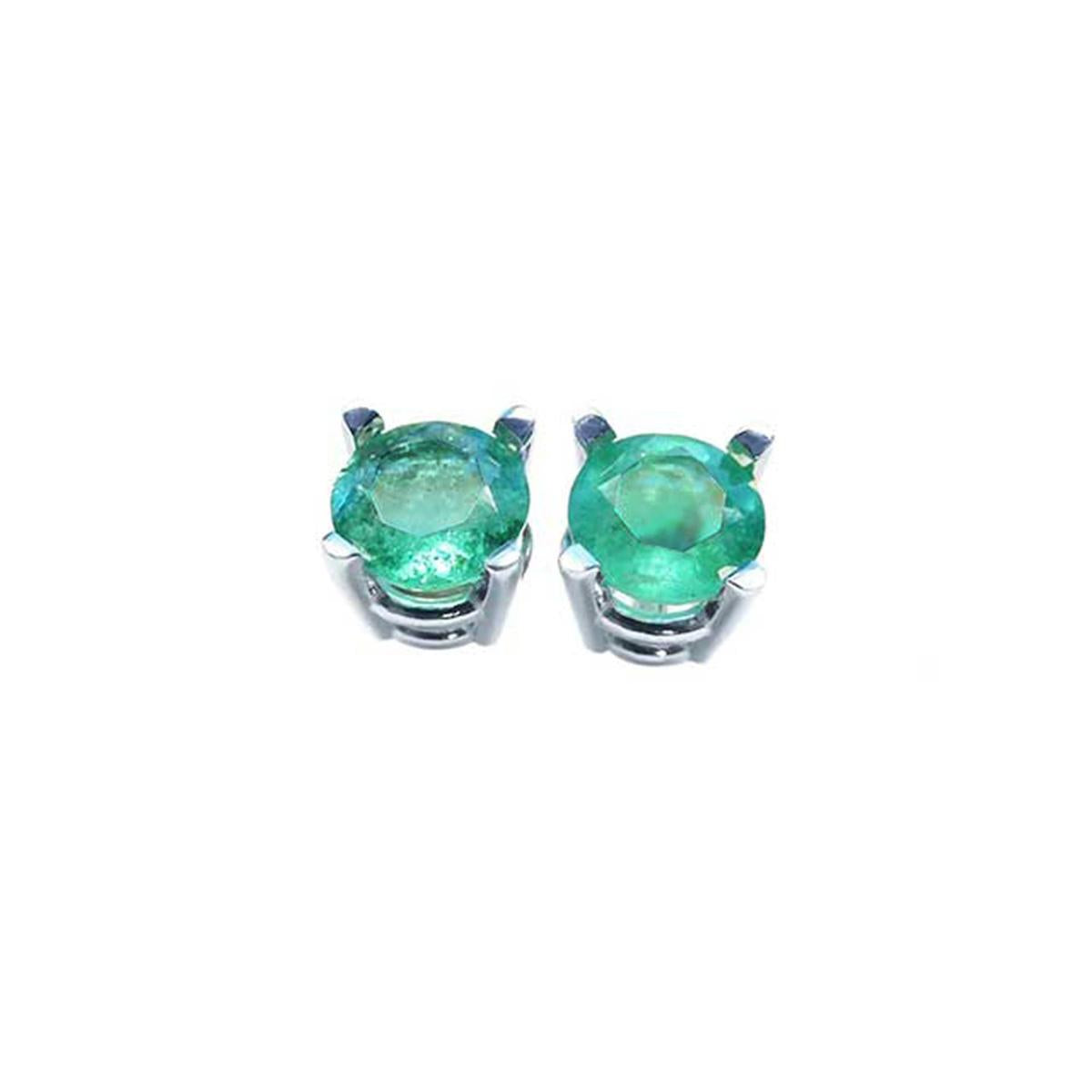 Pair of emerald stud earrings on a front side position top view.