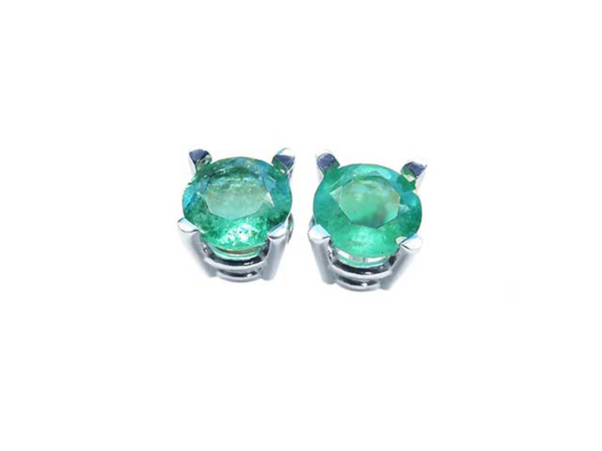 Pair of emerald stud earrings on a front side position top view.
