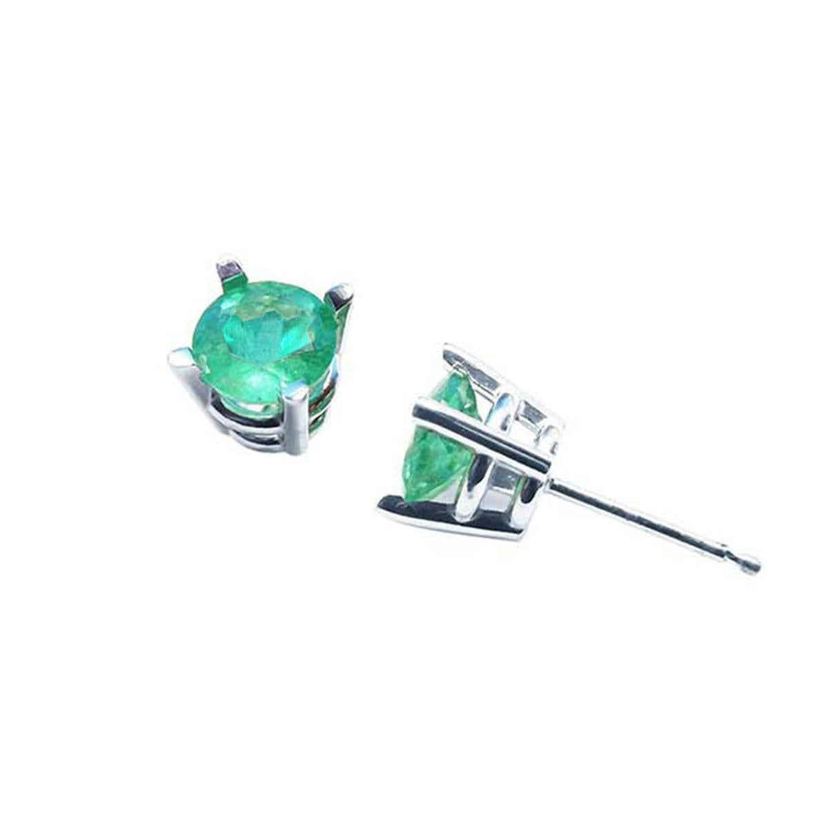 Pair of emerald stud earrings white gold on a top and underside view.