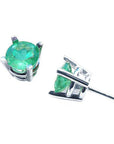 Pair of emerald stud earrings white gold on a top and underside view.