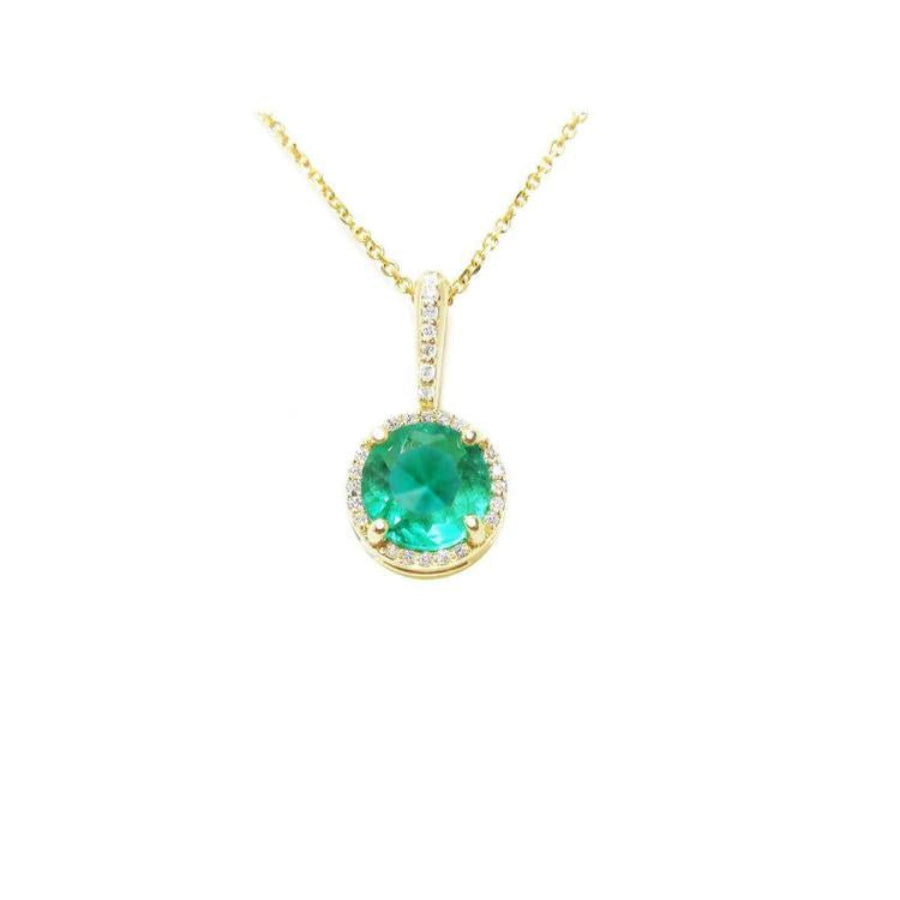 Round-cut natural emerald pendant necklace with halo diamonds in 14K yellow gold.