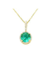 Round-cut natural emerald pendant necklace with halo diamonds in 14K yellow gold.