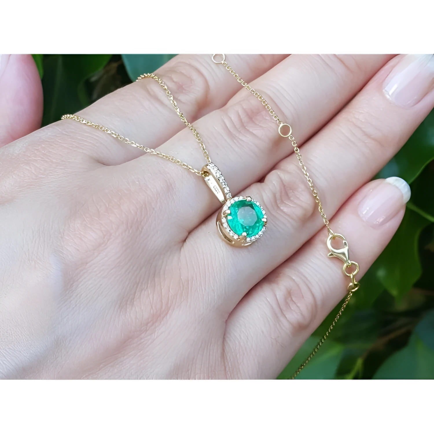 1.80 ct round natural emerald pendant necklace with halo diamonds in 14K yellow gold.