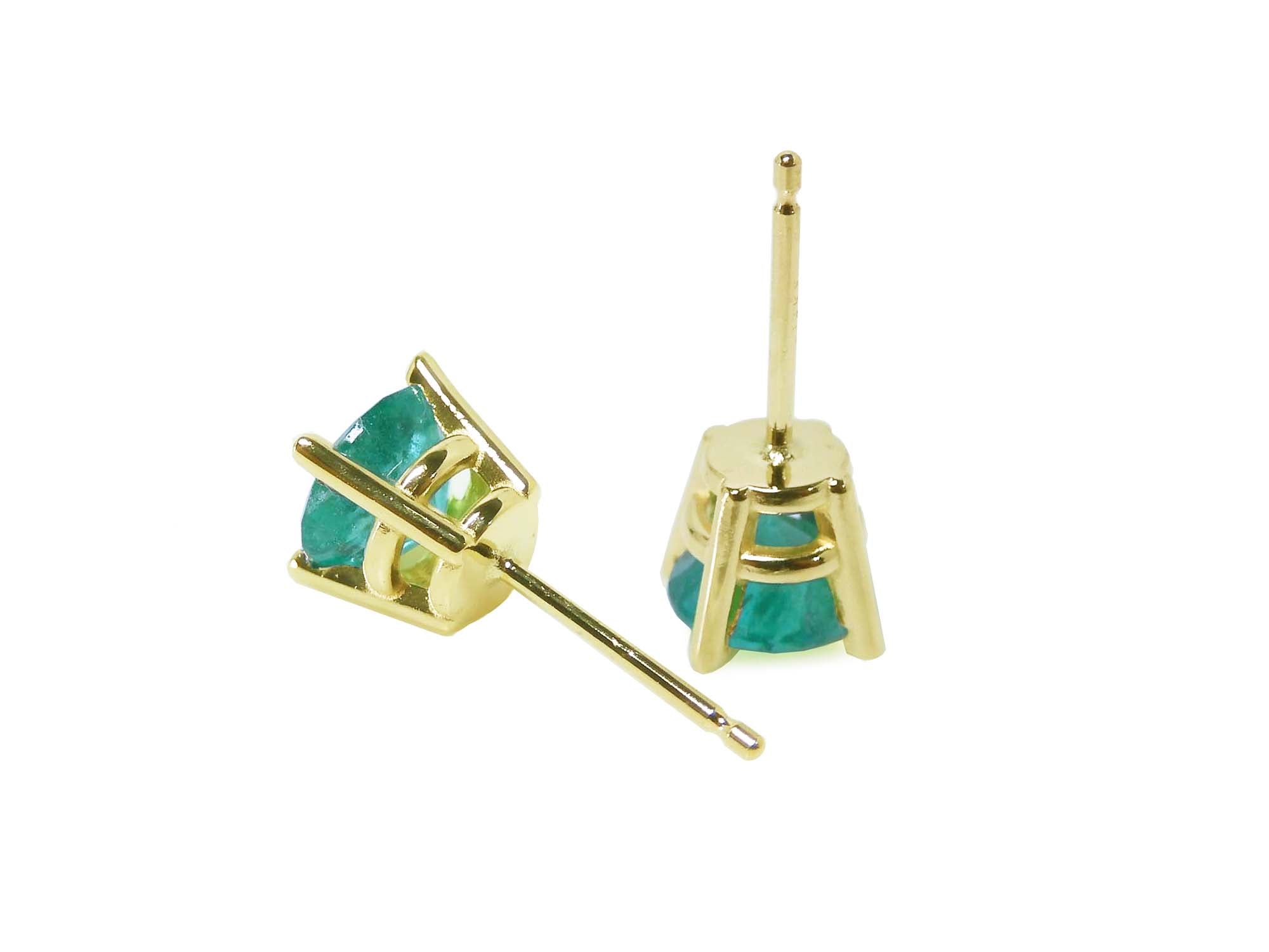 A pair of 14k yellow gold emerald stud earrings round cut, upside down and downside view.