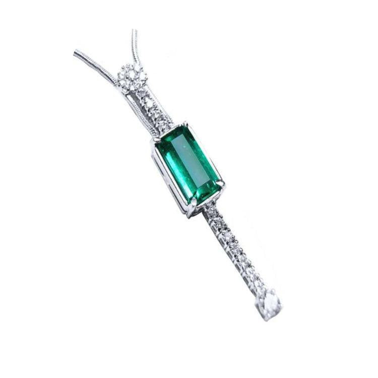 A women's natural Colombian emerald necklace, accented by straight line of natural diamonds crafted in 14k white gold.