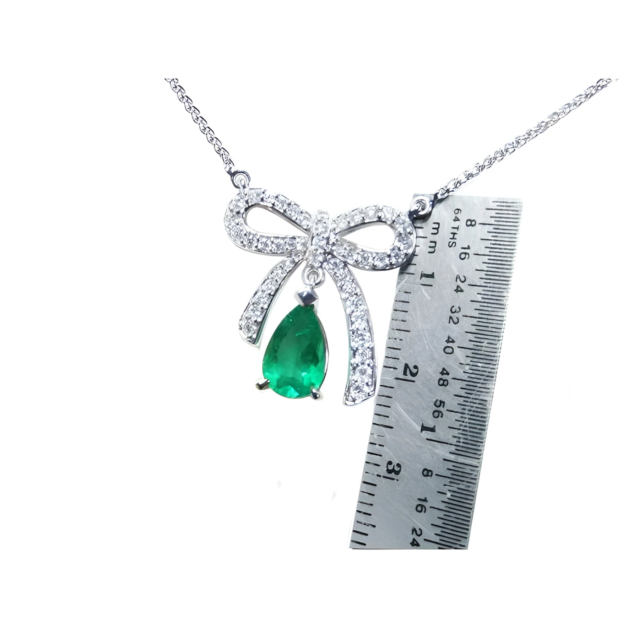 18K white gold bow-tie necklace with a pear-shaped deep green emerald.