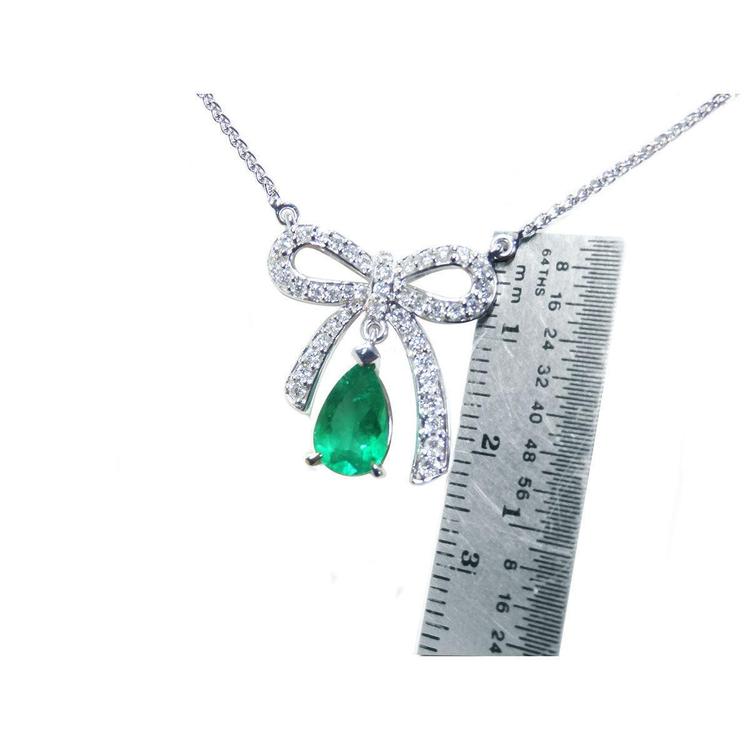18K white gold bow-tie necklace with a pear-shaped deep green emerald.