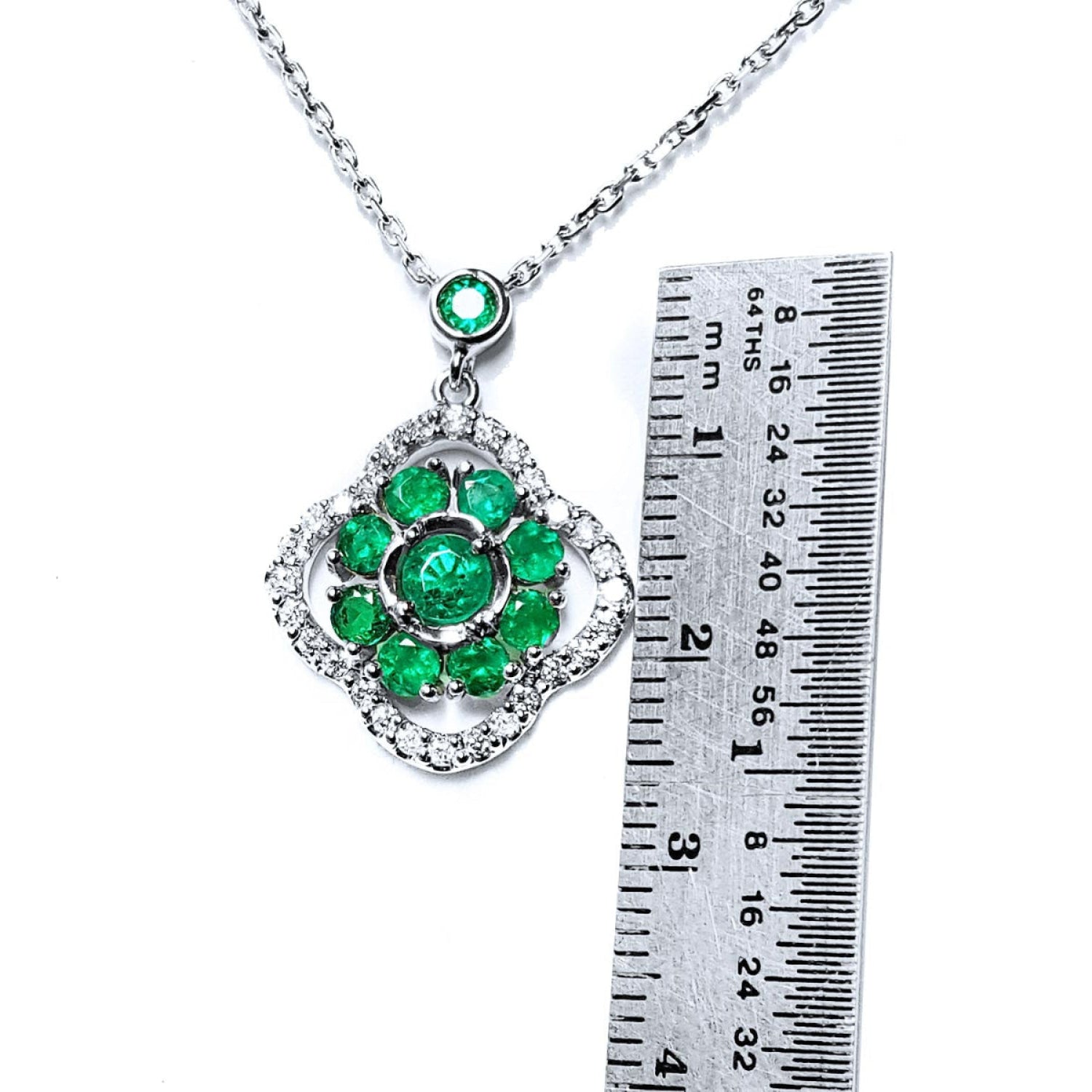 14K white gold cluster necklace with natural Colombian emeralds in a clover design, surrounded by diamonds.