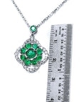 14K white gold cluster necklace with natural Colombian emeralds in a clover design, surrounded by diamonds.