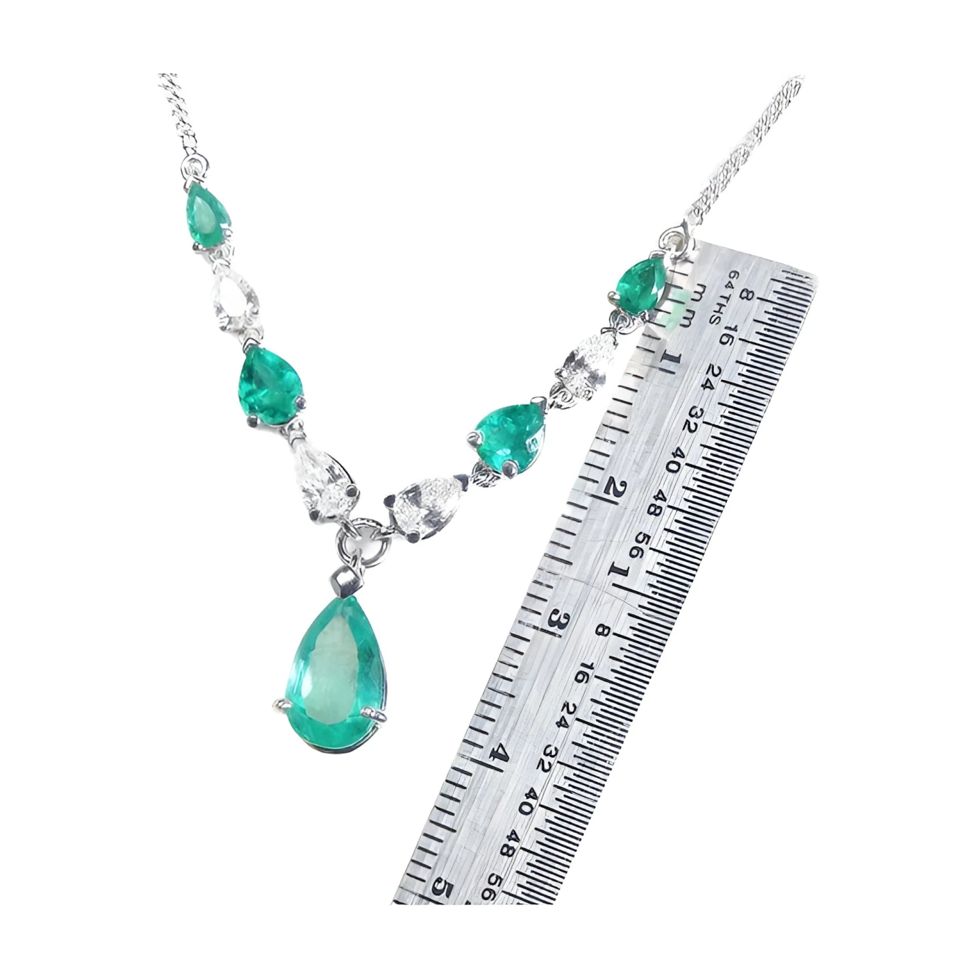 14k white gold necklace with pear-shaped emeralds and diamonds, shown with a ruler for scale.