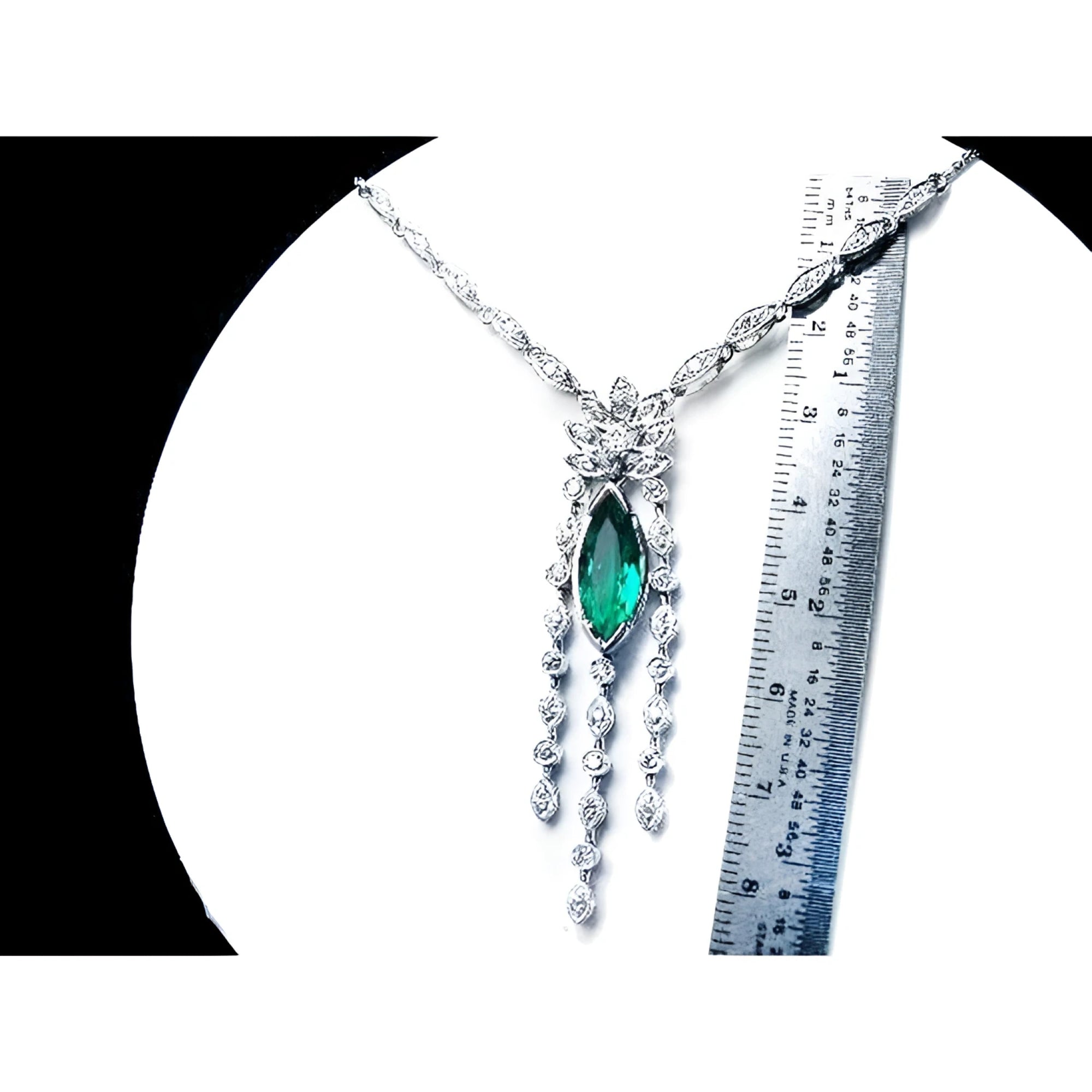 Marquise Colombian emerald and diamond necklace in 14K white gold, shown with a ruler for scale.