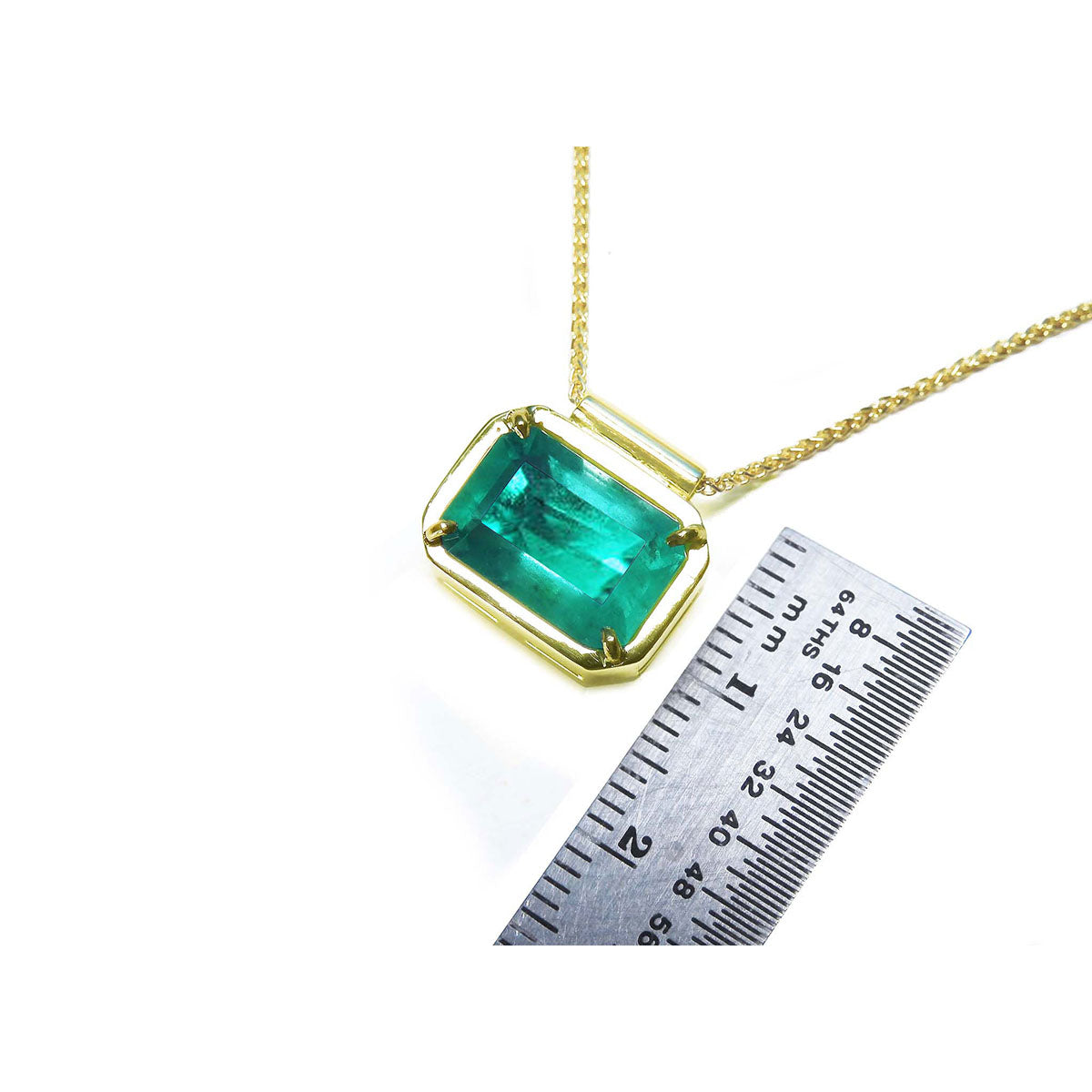 Women&#39;s Emerald solitaire necklace east west orientation rectangular prong set in a handmade setting in 18k yellow gold