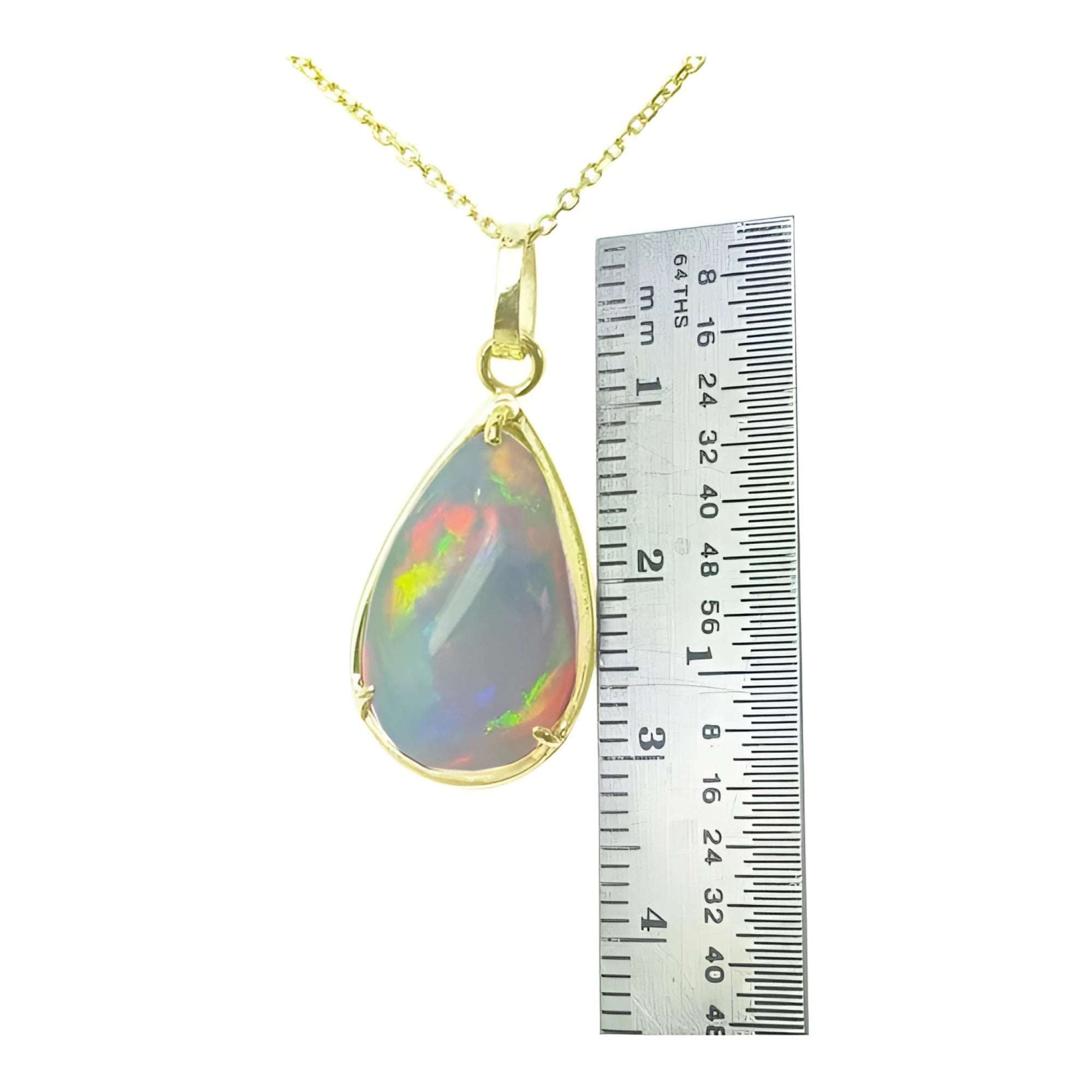 9.29 ct. Ethiopian opal pendant in 14K solid yellow gold, next to a ruler for scale.